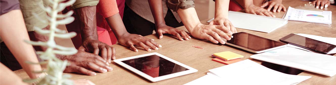 Casual business meeting with tablets on a table.