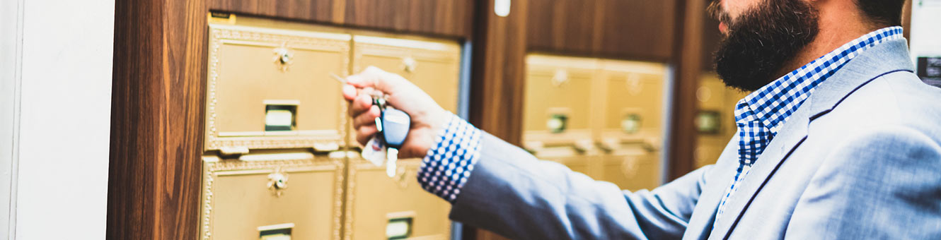 Man opening mailbox with key.